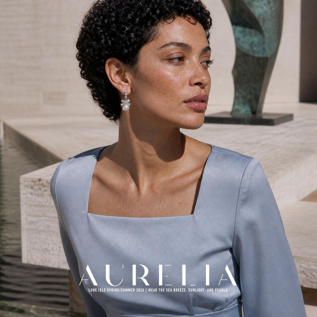 Model in pale blue wearing three upper accents, a bow and round white drop.
