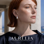 Forward-facing portrait with the earring visible. Single clear accent in a four-prong cool-colored setting directly above a round white bead; same stacked silhouette in all worn views.