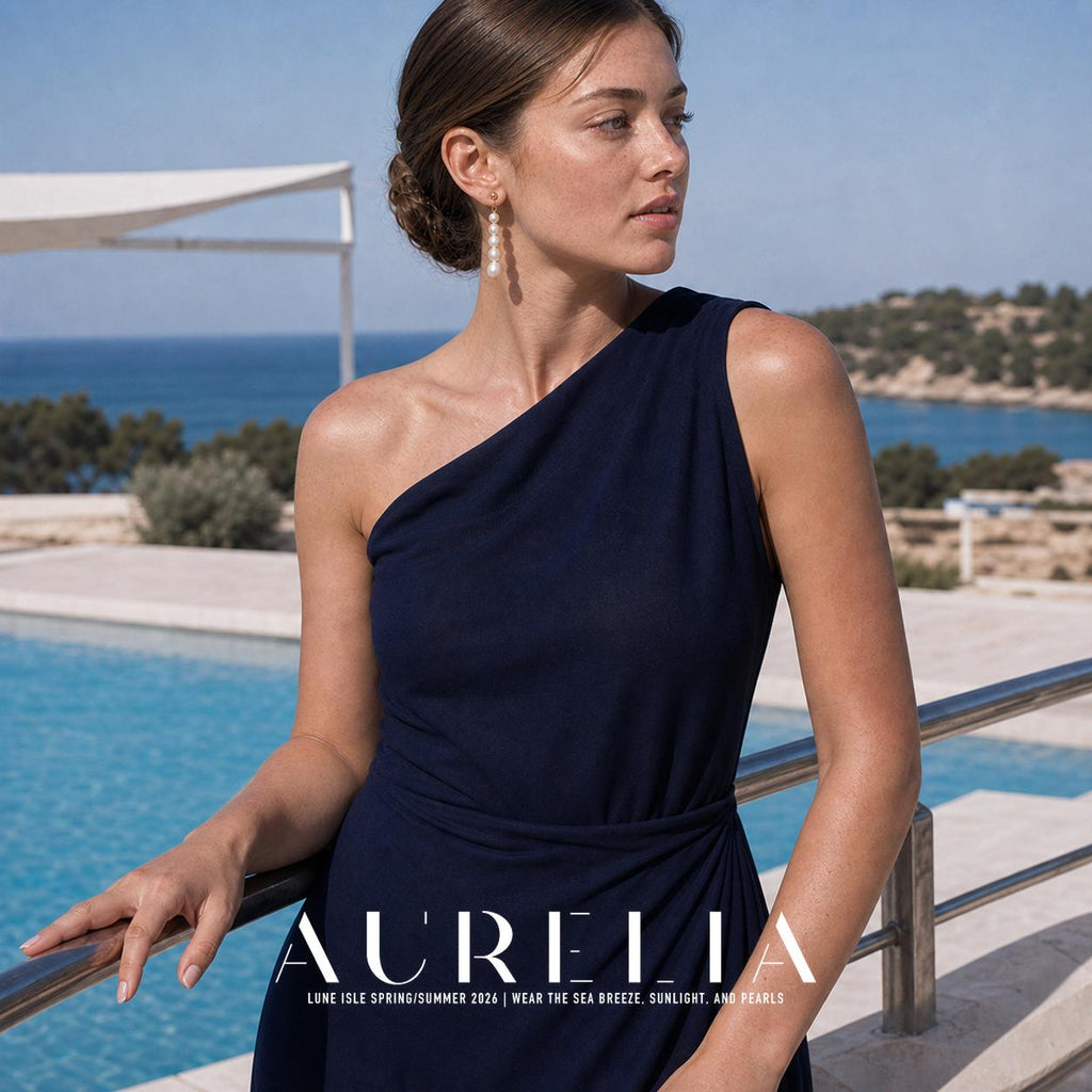 Poolside waist-up portrait in navy, showing a straight five-bead earring below the gold-tone stud.