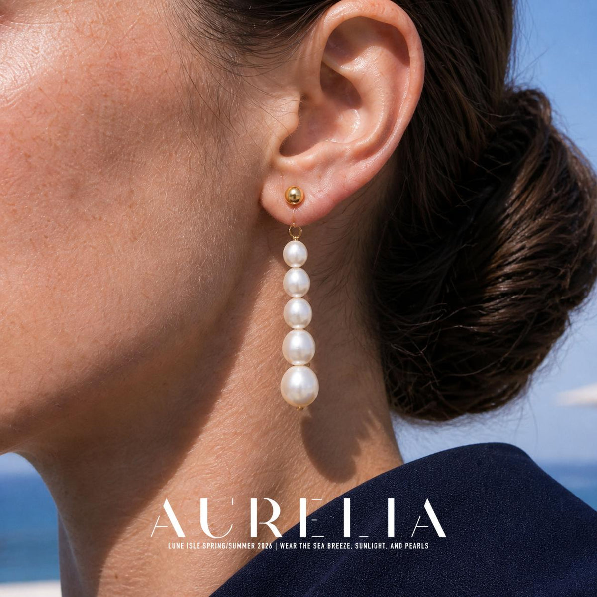 Close ear view clearly showing the gold-tone ball top and five-bead graduated drop.