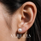 Close ear view showing the plain round white stud.