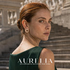 Over-shoulder portrait on stone stairs showing the circular earring unobstructed.