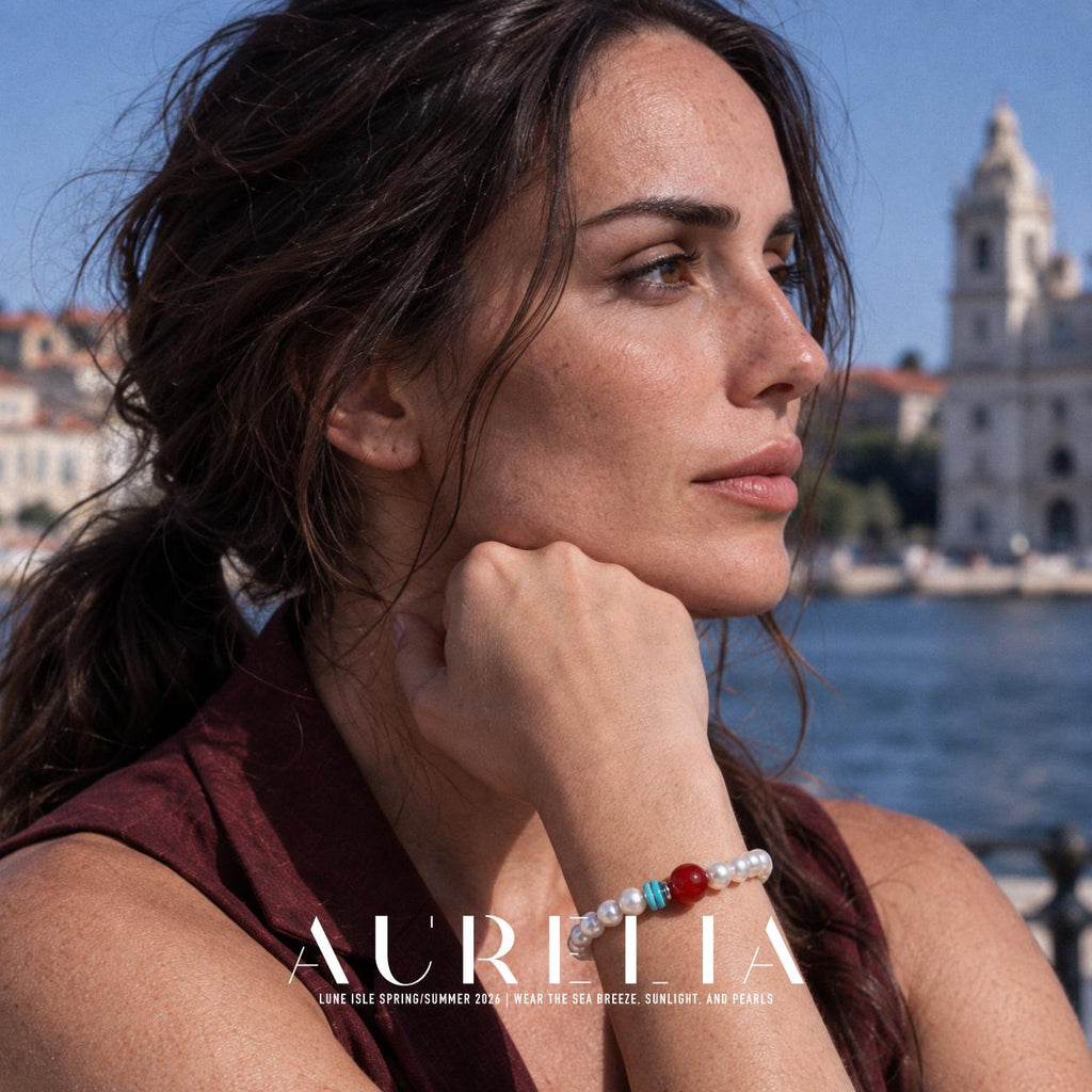 Model resting chin near hand, bracelet visible. White bead strand with one larger red round accent, two turquoise-colored disc spacers and a silver-colored spacer; all worn views preserve this arrangement.